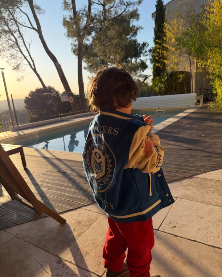 Un enfant devant une piscine au coucher du soleil en Provence